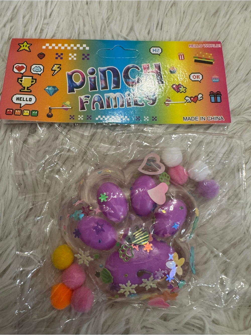 Purple paw squishy with pompoms and confetti